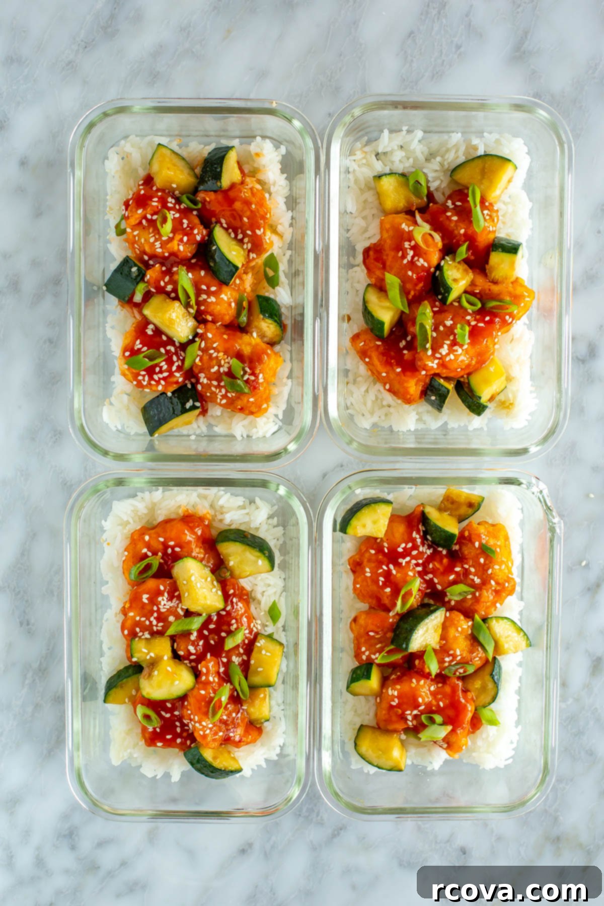Explosive Firecracker Chicken Dinner 10 Four perfectly portioned glass meal prep containers, each filled with a serving of sweet and spicy Firecracker Chicken, rice, and zucchini, ready for the week.