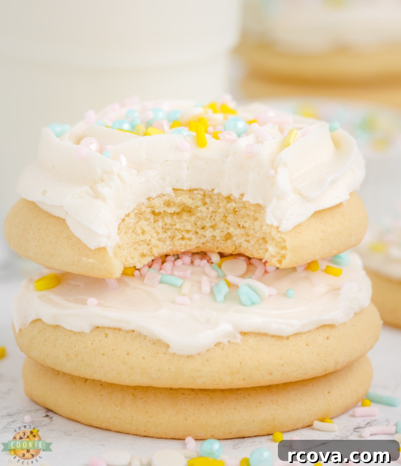 Pillowy Soft Sugar Cookies 2 sugar cookie with a bite taken out, showing its soft interior