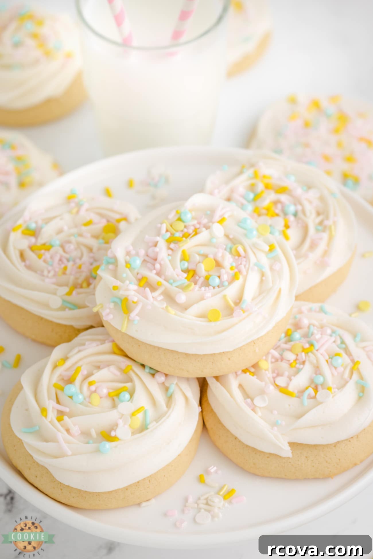 Pillowy Soft Sugar Cookies 3 frosted sugar cookies neatly arranged on a white plate