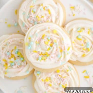 Pillowy Soft Sugar Cookies 8 soft and buttery sugar cookies with frosting and sprinkles on a plate