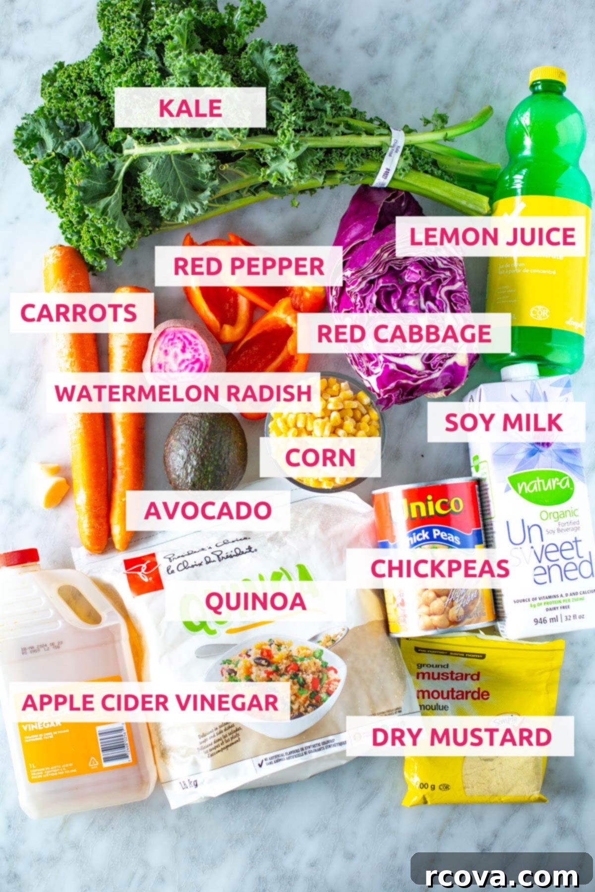 Vibrant Rainbow Harvest Bowl 4 A flat lay photograph displaying all the fresh and colorful ingredients needed for the rainbow veggie bowls, including kale, carrots, red pepper, red cabbage, lemon, garlic, avocado, watermelon radish, corn, soy milk, apple cider vinegar, quinoa, chickpeas, and dry mustard.