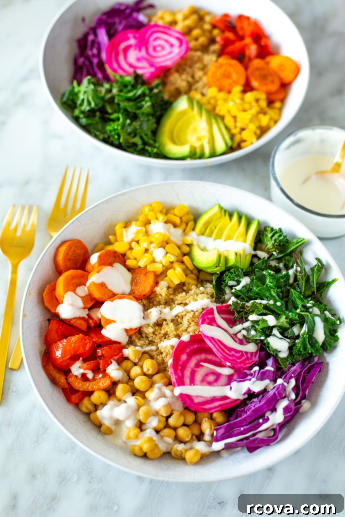 Vibrant Rainbow Harvest Bowl 7 Two vibrant rainbow veggie bowls, each generously drizzled with the creamy homemade garlic dressing, showcasing the beautiful layering of ingredients.