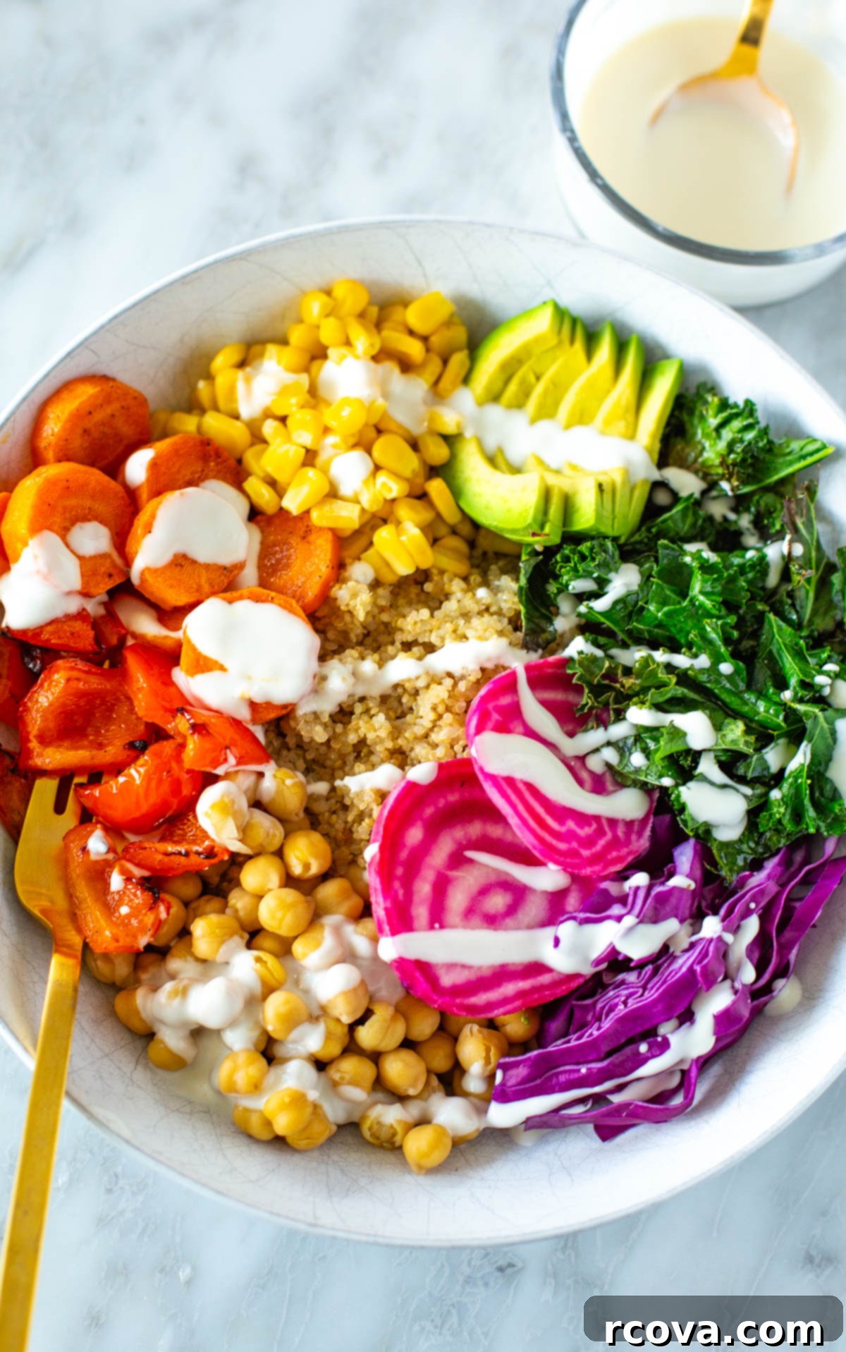 Vibrant Rainbow Harvest Bowl 9 A beautifully composed rainbow veggie bowl with garlic dressing on top, highlighting the fresh, diverse ingredients and appealing presentation.