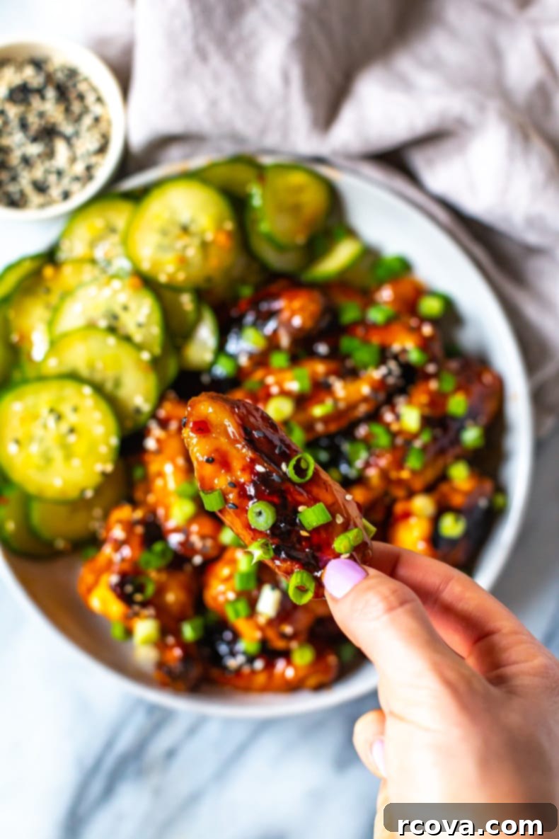 Korean Sticky Oven Wings 8 Close-up shot of glossy, baked Korean Chicken Wings garnished with green onions and sesame seeds