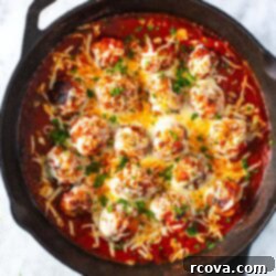 Cheesy Chicken Parmesan Meatballs 11 A skillet of chicken parm meatballs topped with mozzarella cheese.