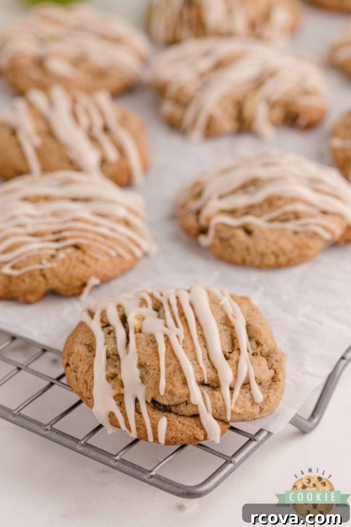 Vanilla Kissed Spiced Apple Treats 7 Freshly baked Vanilla Glazed Spiced Apple Cookies cooling on a wire rack, ready for serving.