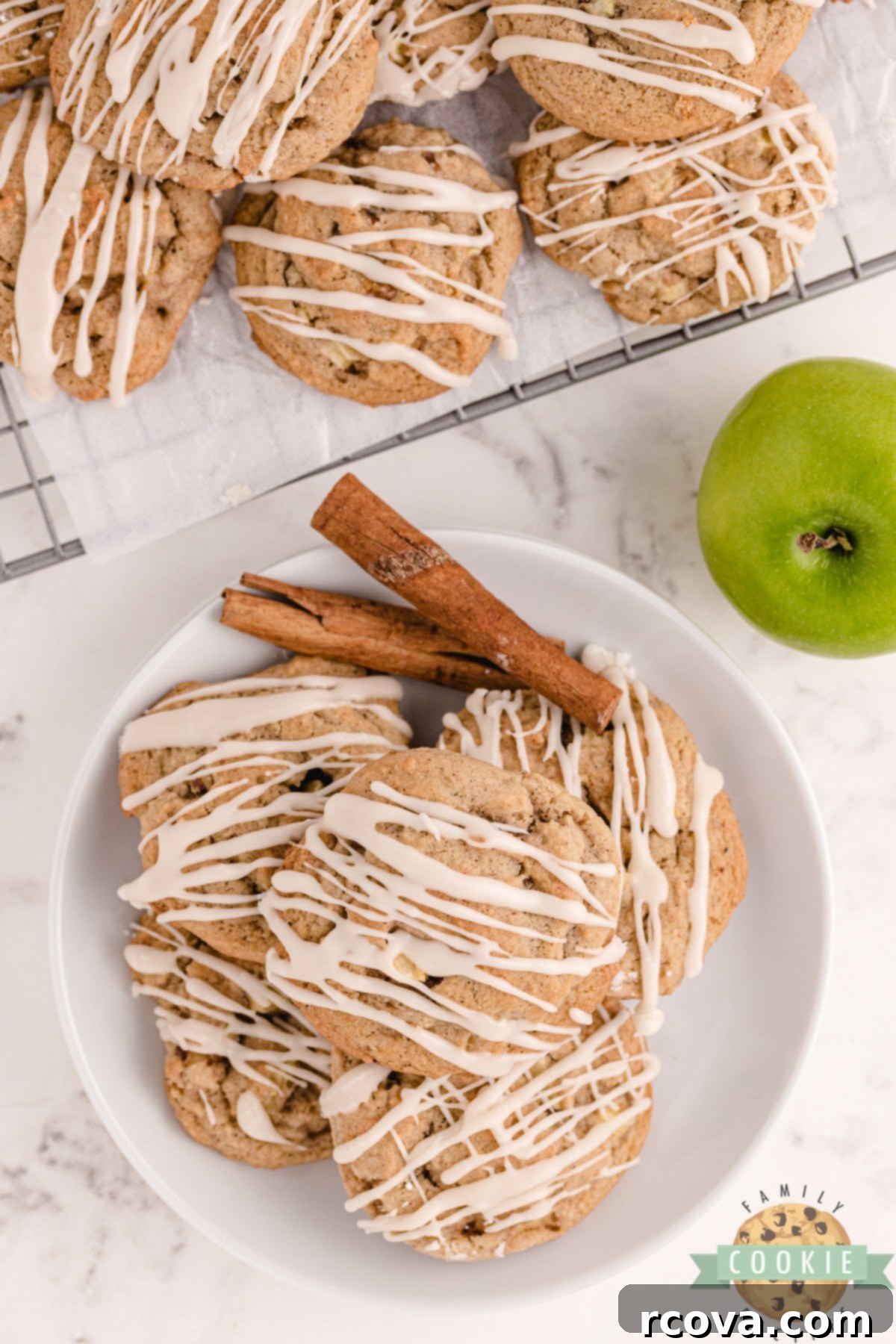 Vanilla Kissed Spiced Apple Treats 8 A stack of vanilla glazed apple cookies, garnished with cinnamon stick, ready to be enjoyed.
