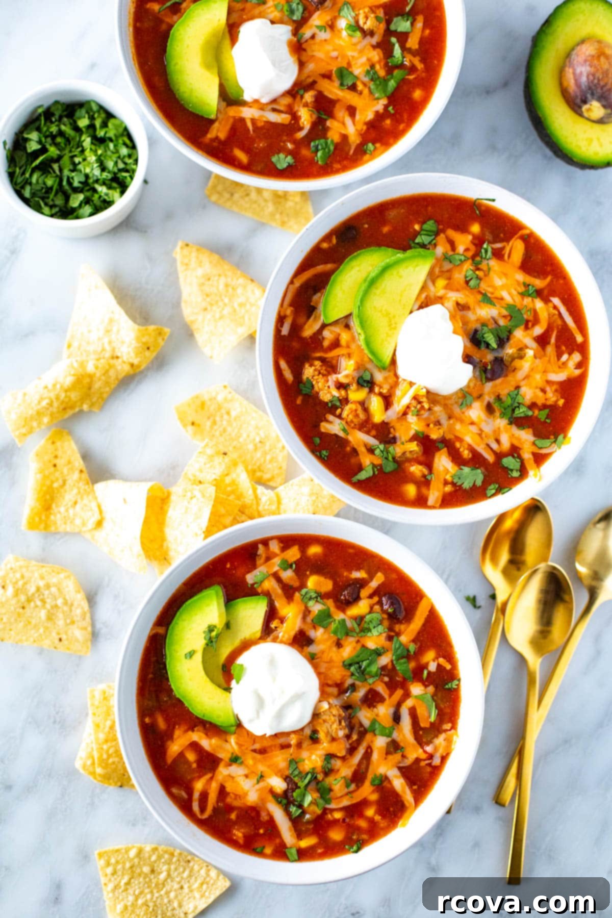Effortless Southwest Chili 2 Three bowls of southwest chili topped with sour cream.