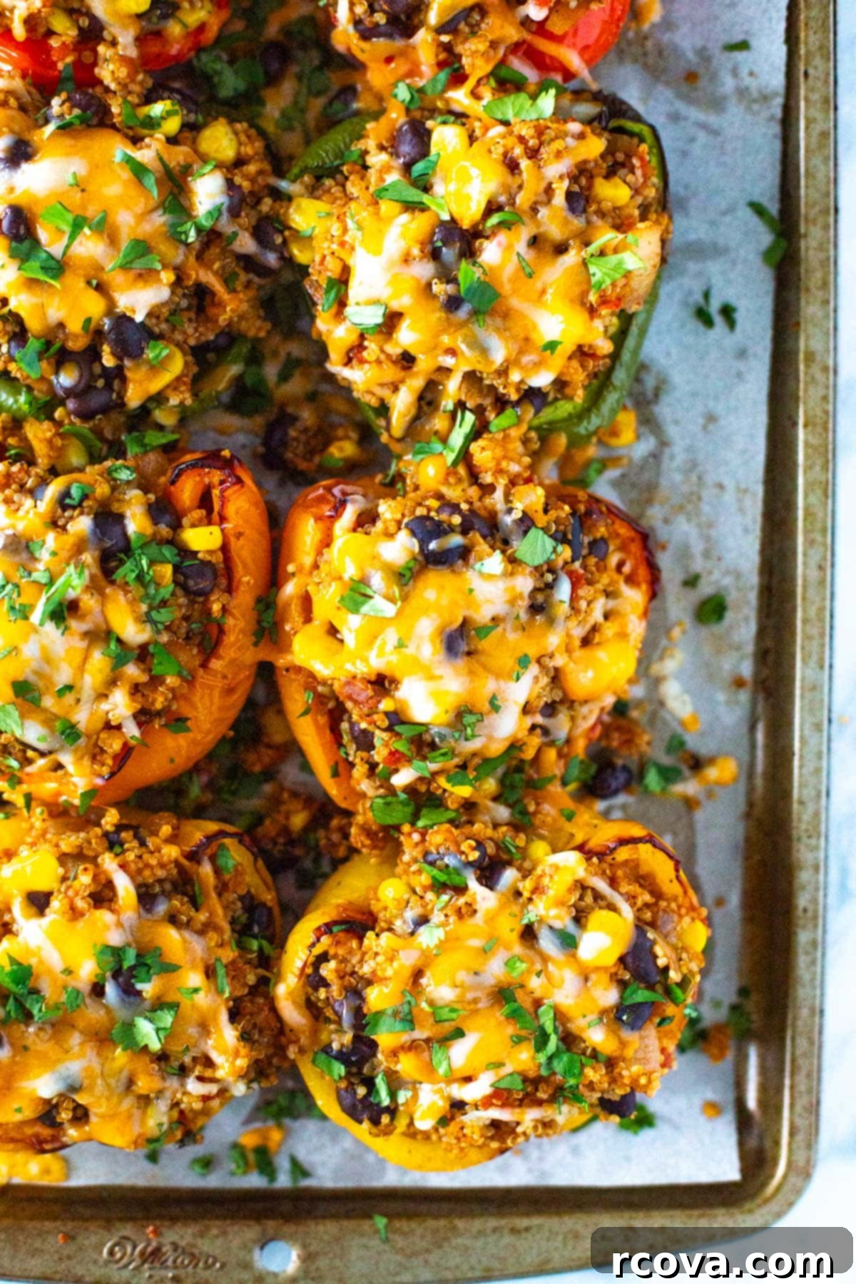 Garden Stuffed Bell Peppers 2 Vegetarian stuffed peppers on a sheet pan.