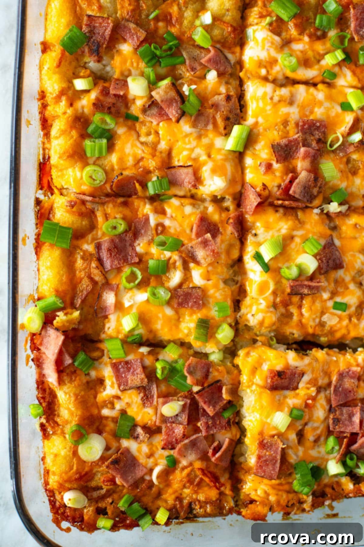 Crunchy Morning Casserole 10 Another close-up shot emphasizing the delicious, comforting nature of the Tater Tot Breakfast Casserole, with golden edges and bubbly cheese.