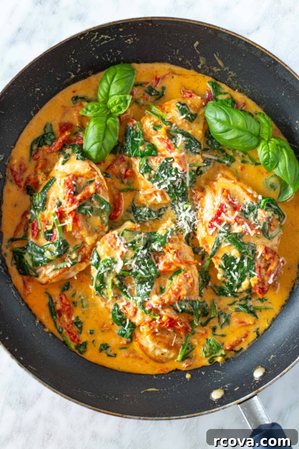 Luxurious Marry Me Chicken 2 A skillet of marry me chicken, garnished with fresh basil, ready to be served.