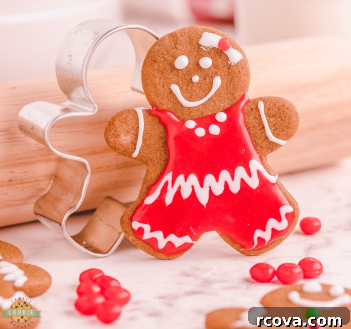Perfectly Crafted Gingerbread Cut-Outs 4 gingerbread girl cookie next to a cookie cutter