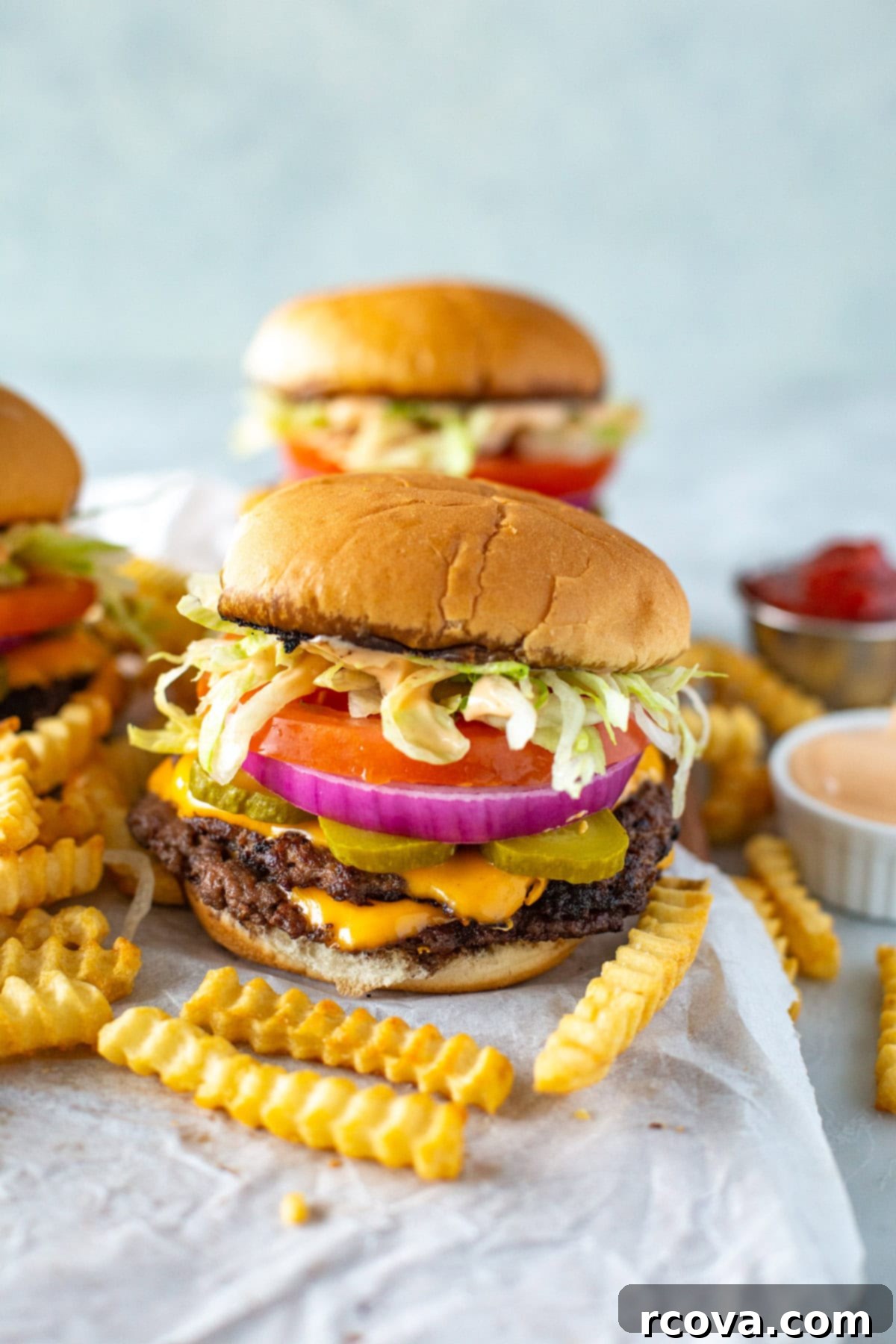 The Perfect Homemade Smash Burger 2 A homemade smash burger with golden-brown fries and dipping sauces, ready to be enjoyed.