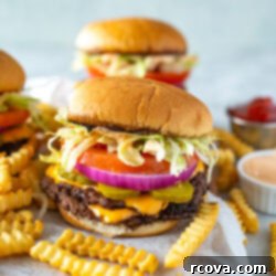 The Perfect Homemade Smash Burger 11 A homemade smash burger with some fries in front of it.