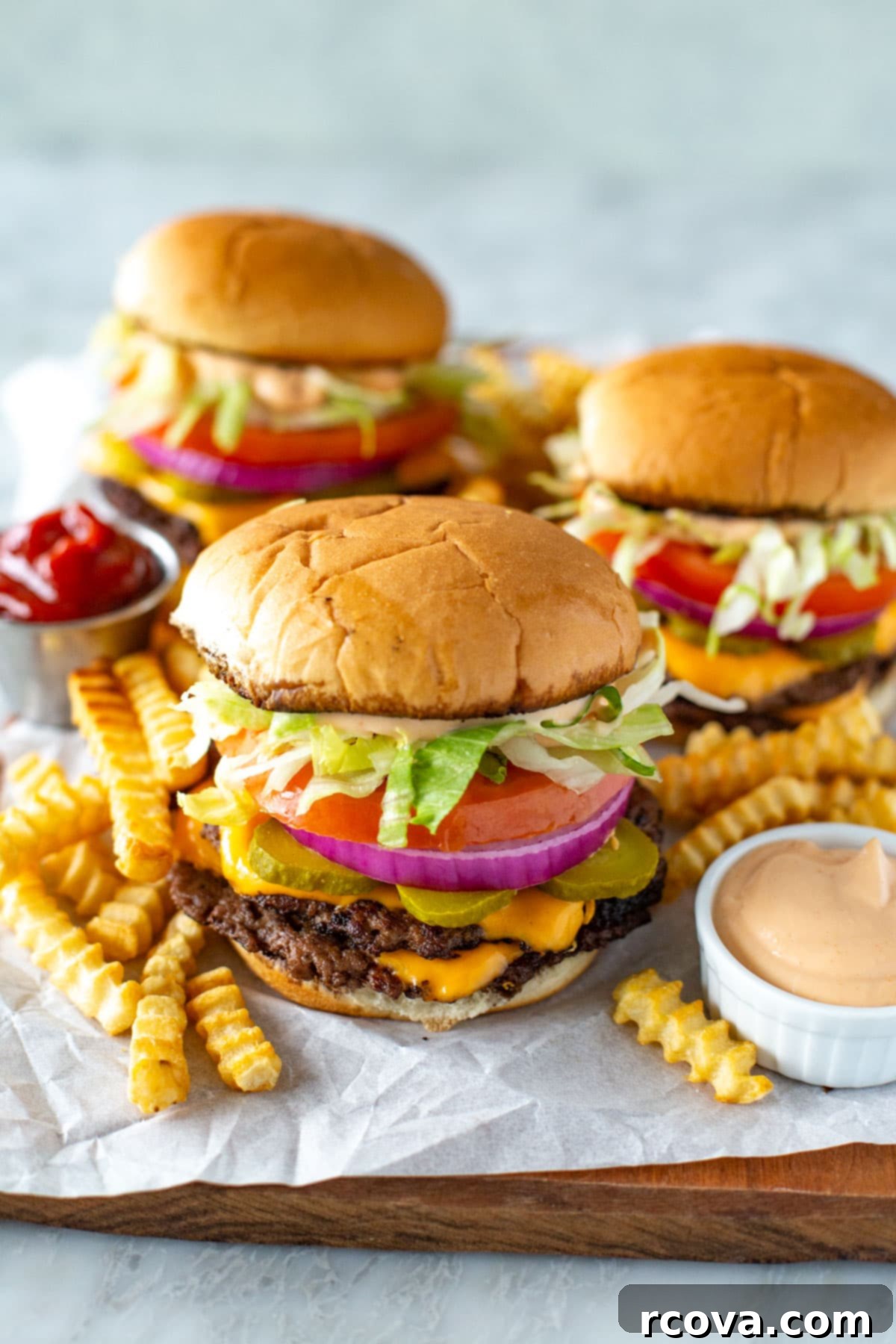 The Perfect Homemade Smash Burger 9 A perfectly cooked smash burger with melted cheese and fresh toppings, served alongside golden fries and special sauce, ready to be enjoyed.