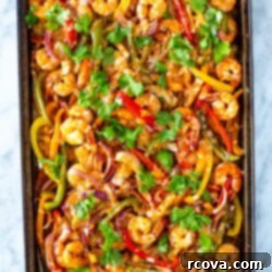 Effortless Sheet Pan Shrimp Fajitas 10 Shrimp fajitas cooked on a sheet pan and topped with cilantro.