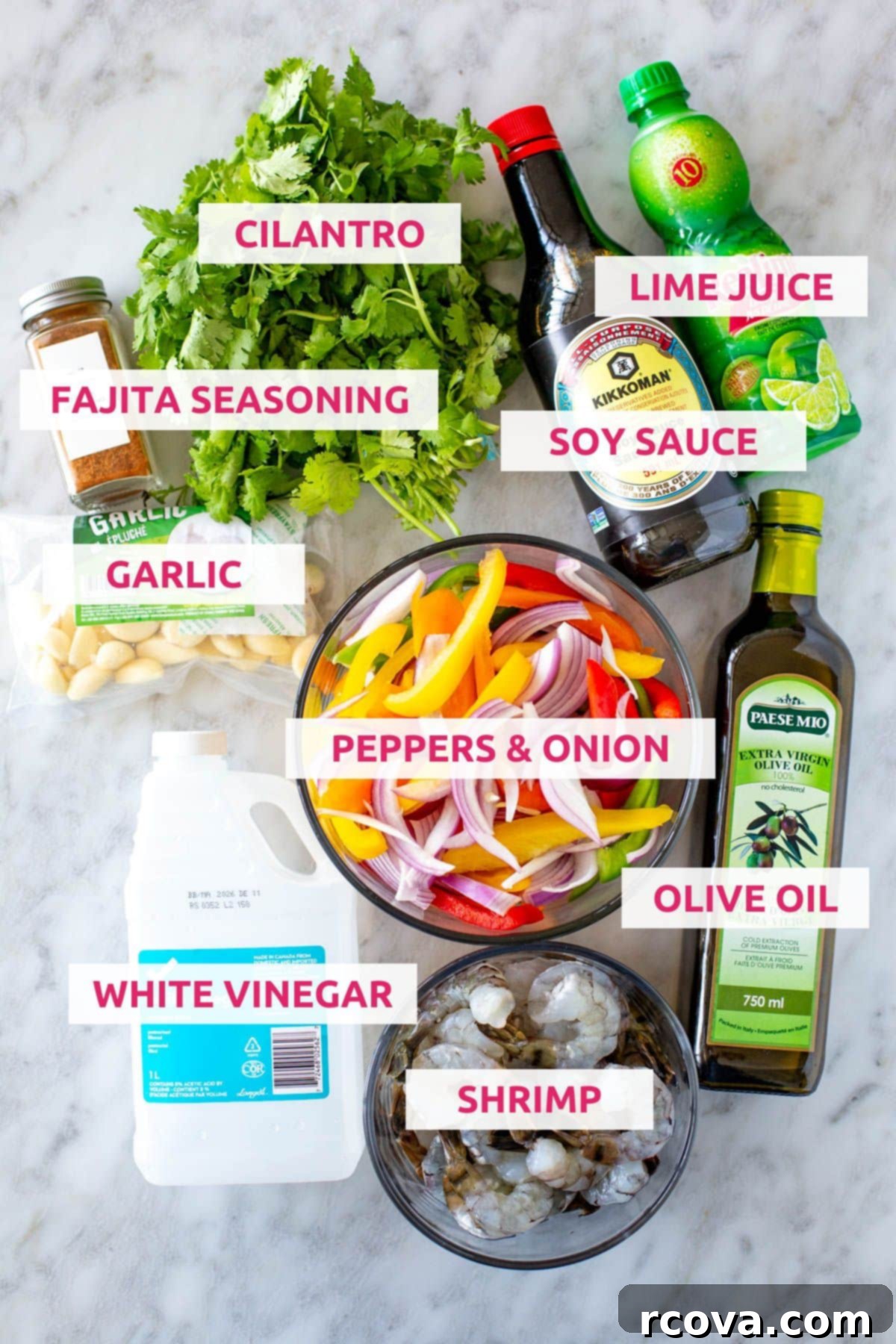 Effortless Sheet Pan Shrimp Fajitas 4 A selection of fresh ingredients laid out: raw shrimp, sliced bell peppers and red onion, cilantro, lime, and small bowls of olive oil, fajita seasoning, lime juice, soy sauce, and white vinegar.