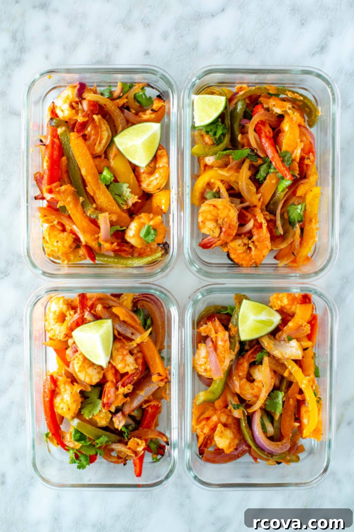 Effortless Sheet Pan Shrimp Fajitas 9 Portioned sheet pan shrimp fajitas packed into clear glass meal prep containers for future meals.