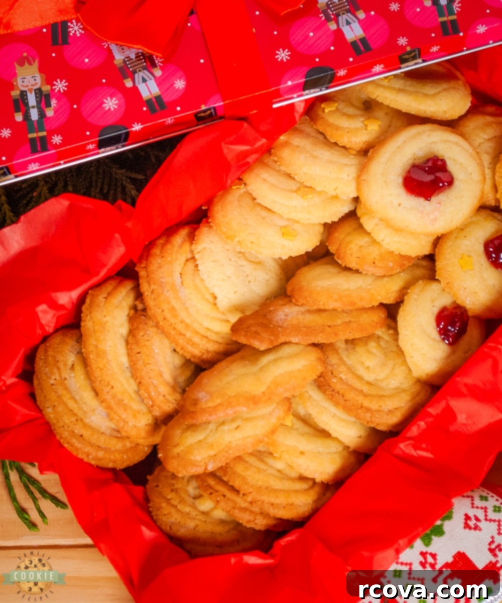 Classic Danish Butter Delights 7 Various Danish butter cookies beautifully arranged, some dipped in chocolate, others topped with sprinkles, showcasing their versatility.