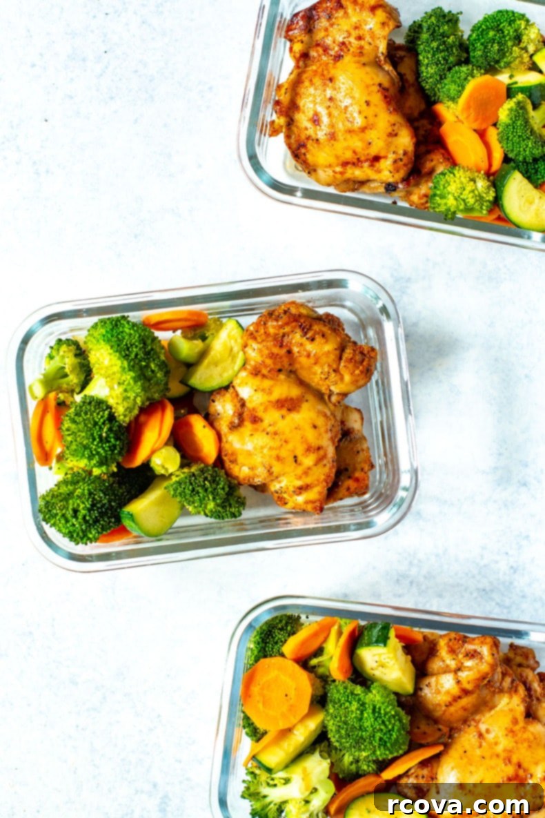 Juicy Baked Boneless Chicken Thighs 6 Three meal prep containers, each filled with broccoli, carrots, zucchini and baked chicken thighs.