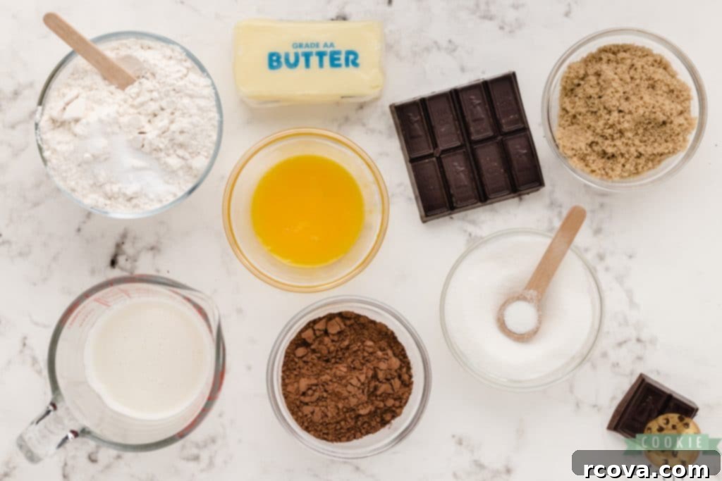 Decadent Double Chocolate Thumbprints 4 Various essential ingredients laid out for making chocolate thumbprint cookies, including flour, cocoa powder, butter, sugars, and dark chocolate for ganache.