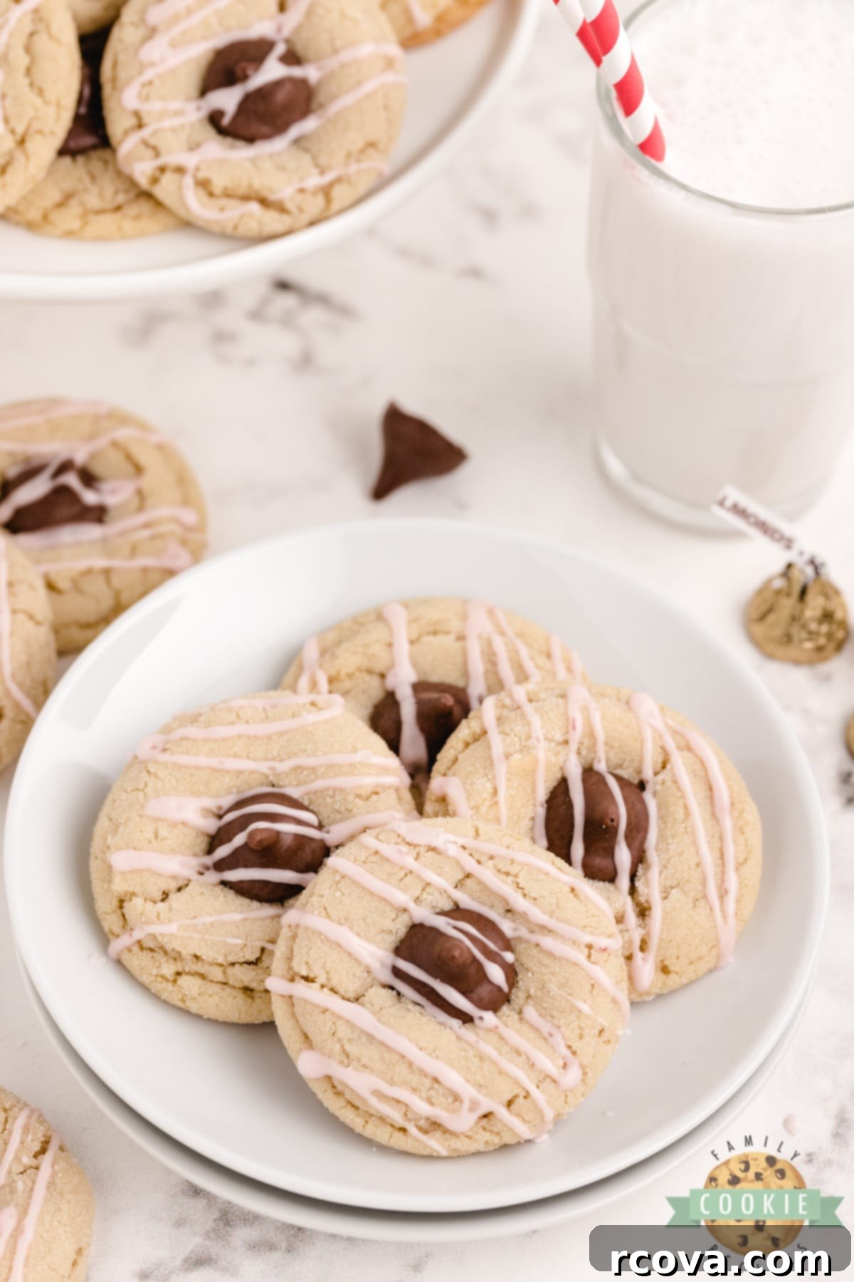 Almond Kissed Delights 7 A plate of Almond Kiss Cookies, perfectly baked with chocolate almond kisses and a vibrant raspberry drizzle, ready to be served.