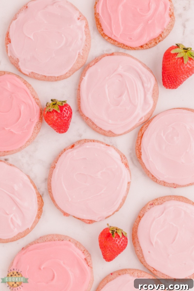 Strawberry Whipped Dream Cookies 5 Dough balls of strawberry cool whip cookies scooped onto a parchment-lined baking sheet, ready for baking
