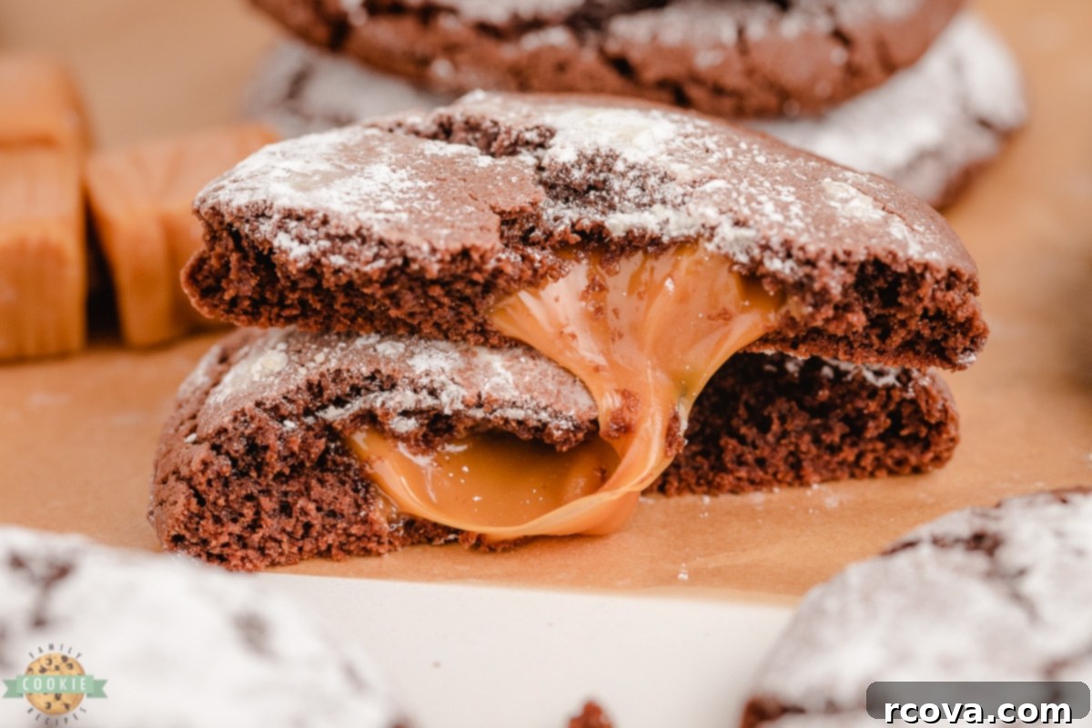Chocolate Crinkles with a Caramel Heart 2 Caramel Chocolate Crinkle Cookies with powdered sugar dusting on a cooling rack.