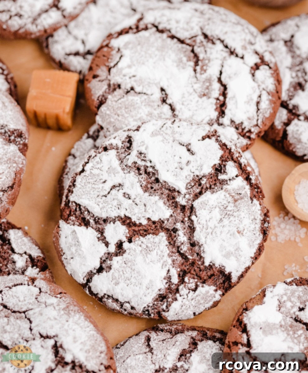 Chocolate Crinkles with a Caramel Heart 3 Close-up of a stack of Caramel Chocolate Crinkle Cookies showing the soft chocolate and powdered sugar crinkles.