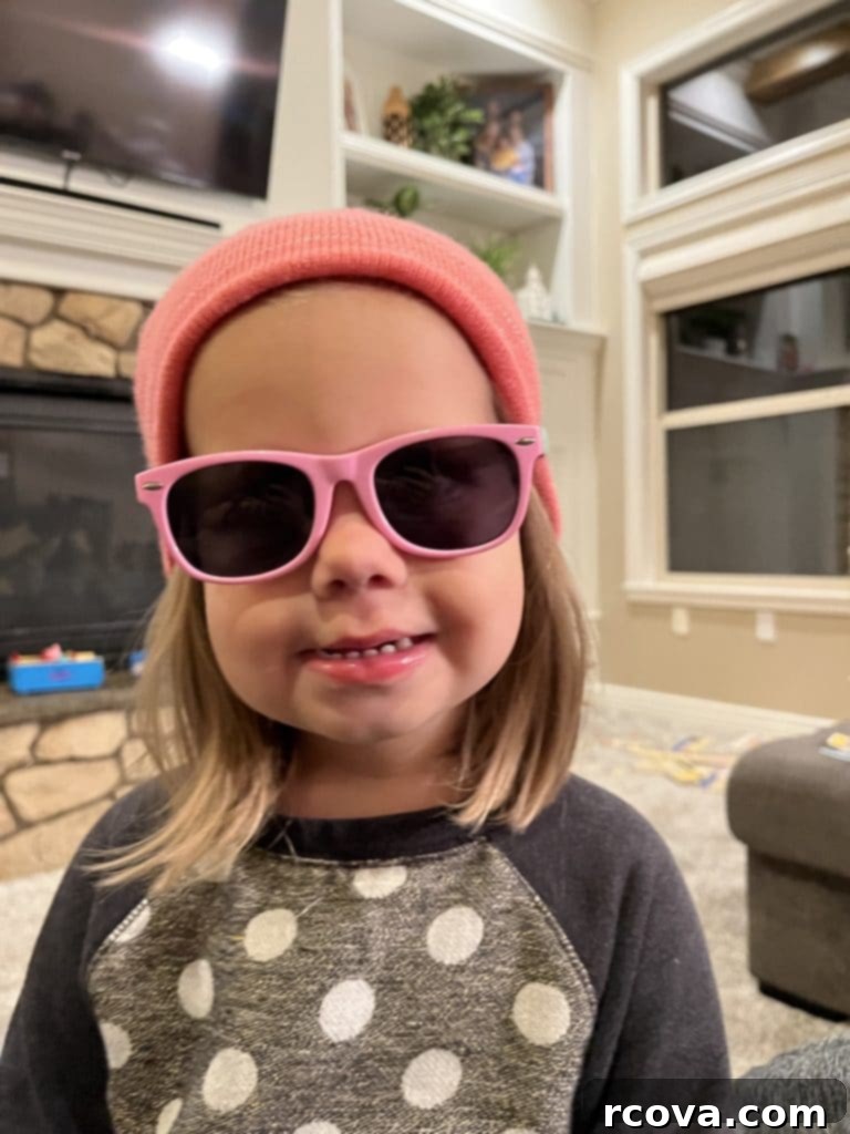 Peanut Butter Chocolate Krispie Crunch Cookies 12 A happy child wearing a ski hat and sunglasses indoors, looking playful and joyful