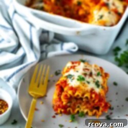 Effortless Lasagna Roll-Ups: A Delicious Family Meal 11 A plate of cheesy spinach lasagna roll-ups topped with melted mozzarella cheese and garnished with fresh basil.