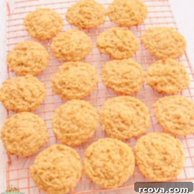 Chewy Coconut Oatmeal Delights 8 Chewy Coconut Oatmeal Cookies cooling on a wire rack.