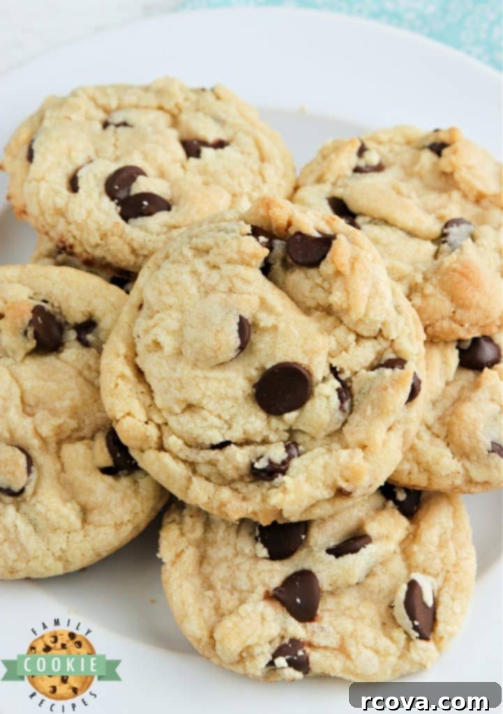 Irresistible Homemade Chocolate Chip Cookie Recipes 3 A stack of perfectly baked, golden-brown chocolate chip cookies with melted chocolate chips visible.