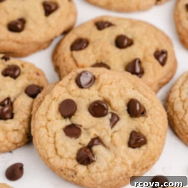 Irresistible Homemade Chocolate Chip Cookie Recipes 4 Close-up of a stack of golden brown, soft chocolate chip cookies, sprinkled with extra chocolate chips.