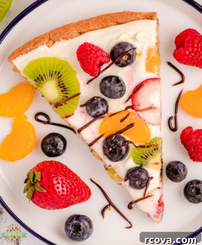 Irresistible Homemade Chocolate Chip Cookie Recipes 38 A slice of Chocolate Chip Cookie Pizza with cream cheese frosting and fresh berries.