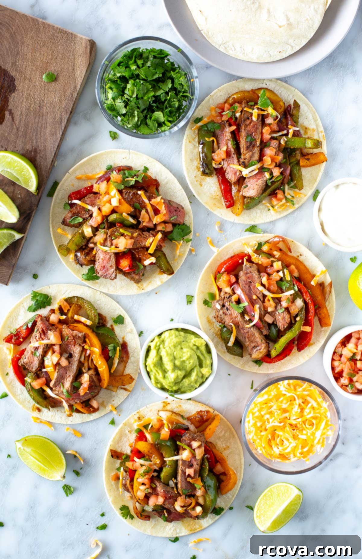 Sizzling Steak Fajitas 8 A vibrant close-up shot of an assembled steak fajita, nestled in a soft tortilla, with visible tender steak strips, colorful bell peppers, and onions, garnished with fresh cilantro and a squeeze of lime.