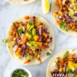 Deliciously Simple Jackfruit Tacos 11 Overhead shot of jackfruit tacos on a marble surface.