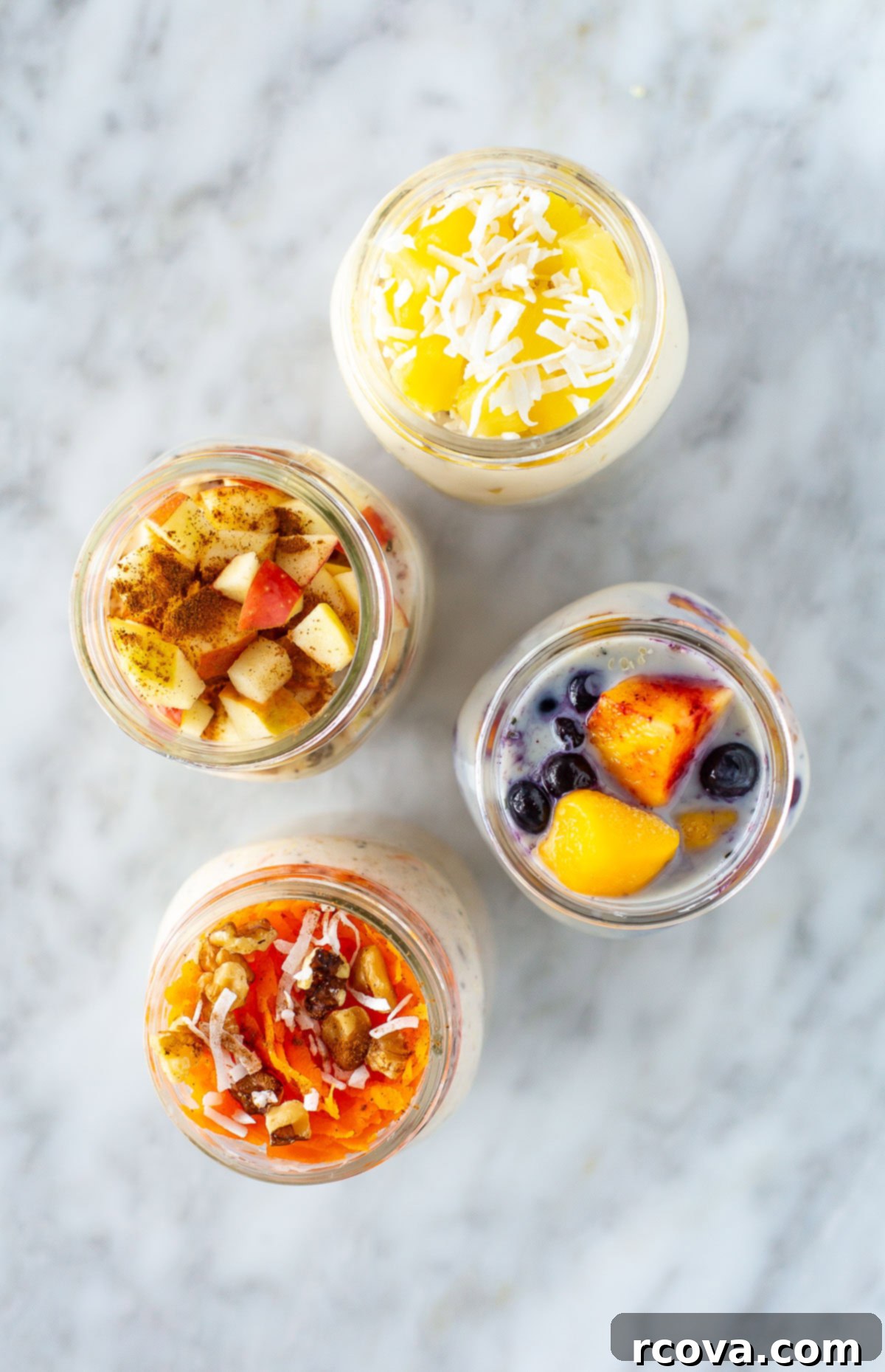30g Protein Power Overnight Oats 7 Overhead shot of four colorful mason jars of high protein overnight oats with different delicious toppings.