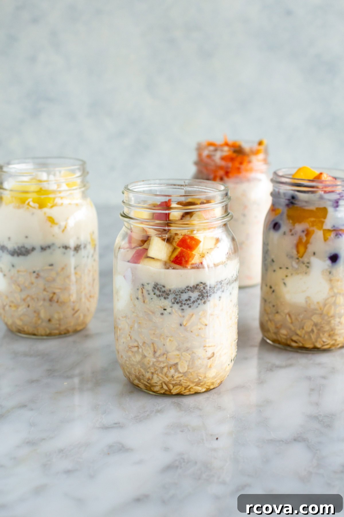 30g Protein Power Overnight Oats 8 side shot of four mason jars of high protein overnight oats with various toppings and spoons