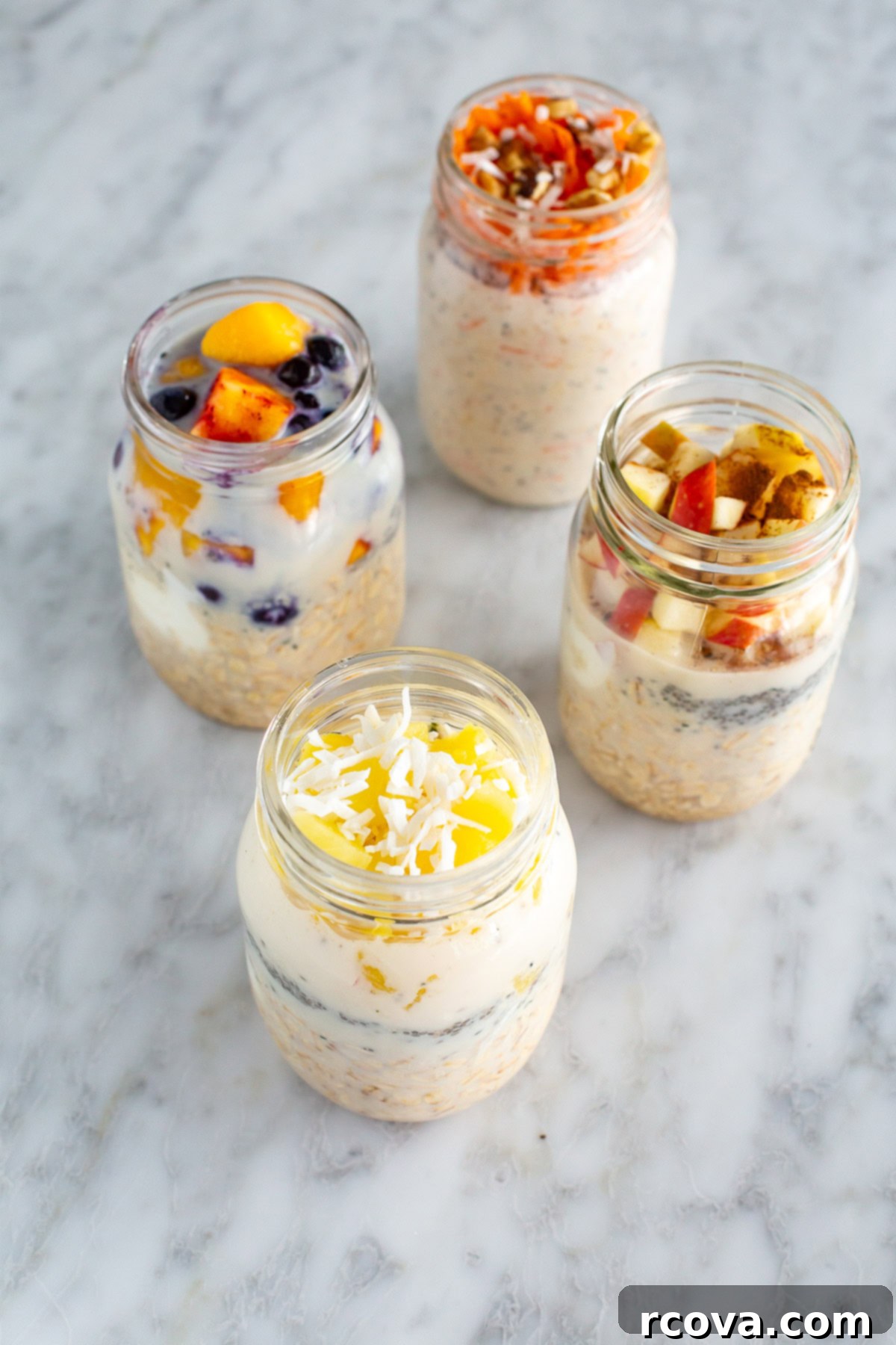 30g Protein Power Overnight Oats 9 Four beautifully arranged mason jars of high protein overnight oats with different toppings on a light background.