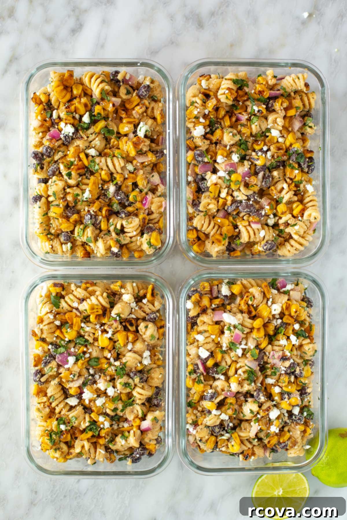 Fiesta Elote Pasta Salad 8 Overhead shot of four containers of Mexican street corn pasta salad.