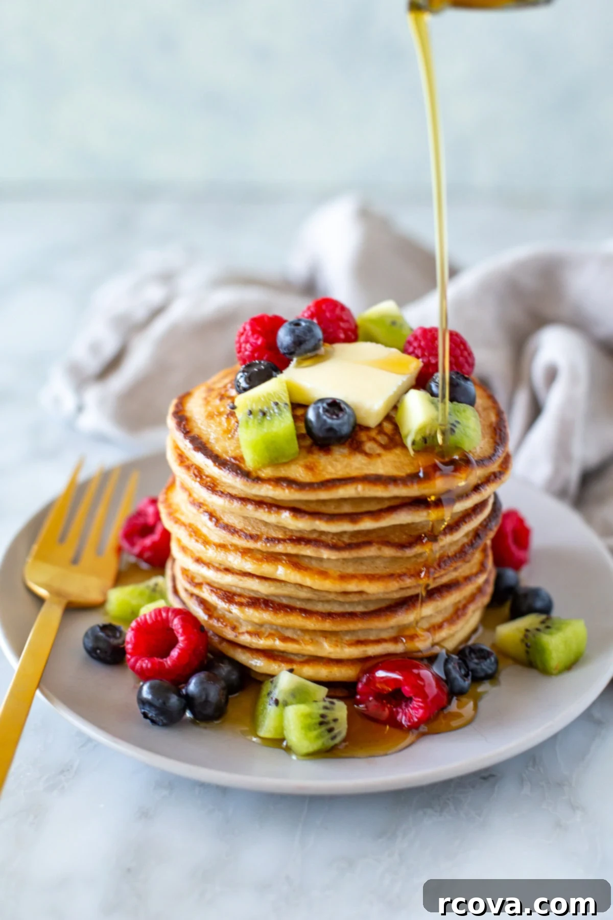 Protein-Packed Cottage Cheese Pancakes 2 Overhead shot of cottage cheese pancakes with berries on top and around - 2