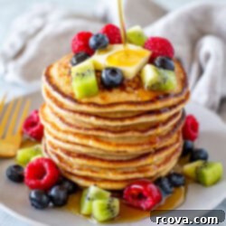 Protein-Packed Cottage Cheese Pancakes 11 Overhead shot of cottage cheese pancakes with berries on top and around - 3