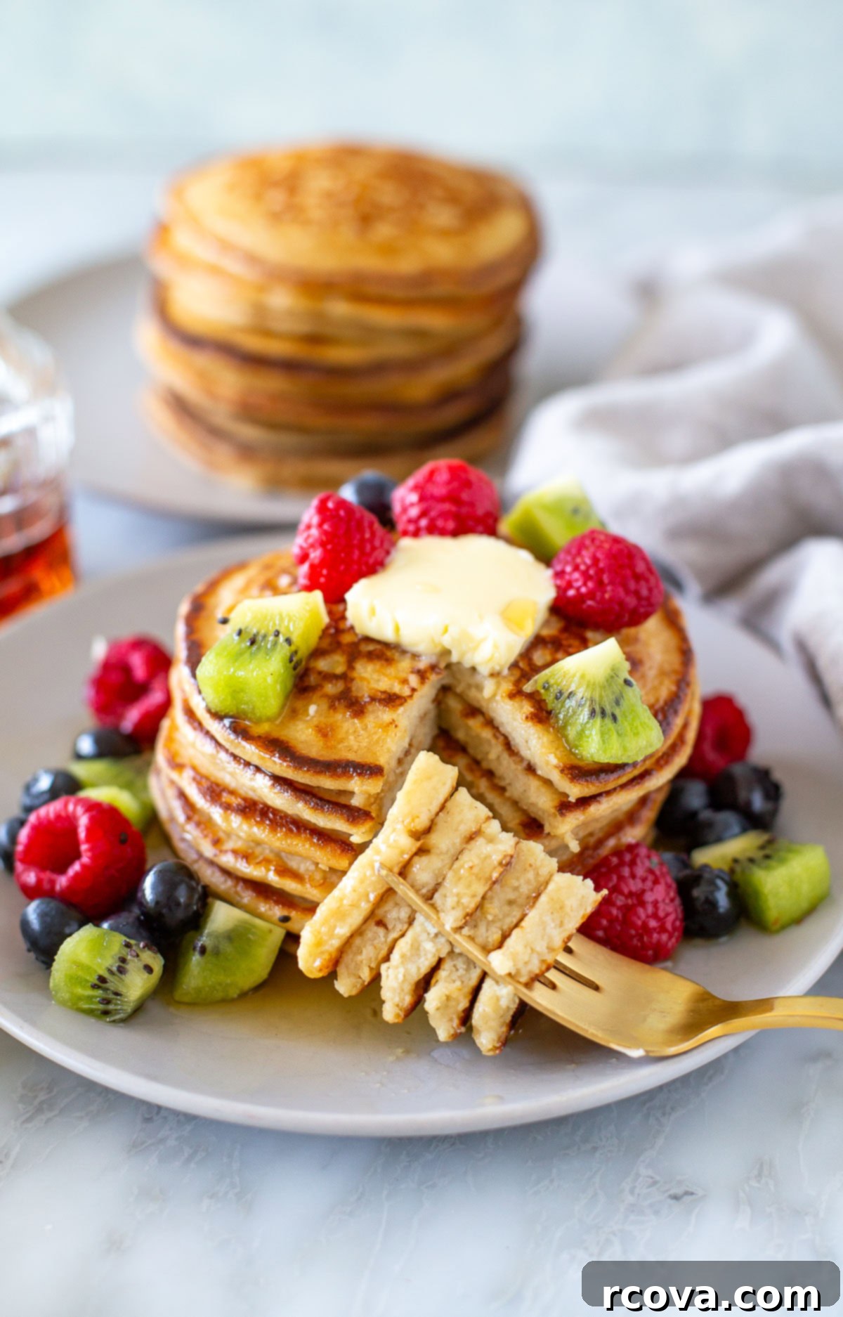 Protein-Packed Cottage Cheese Pancakes 8 Overhead shot of cottage cheese pancakes with berries on top and around with sliced one