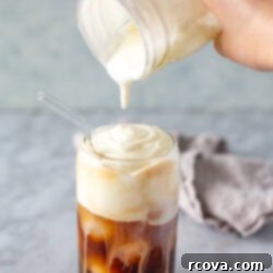 Effortless Cold Foam Perfection 9 Pouring thick, creamy cold foam overtop of iced espresso
