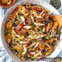 Vibrant Mandarin Chicken Salad 11 A big bowl of Mandarin Chicken salad with toppings on it.