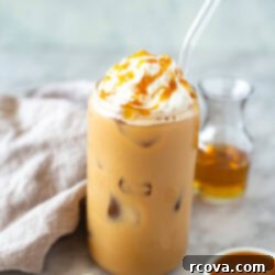 Effortless Iced Caramel Latte Dream 9 Side shot of an iced caramel latte with whipped cream and caramel drizzle.