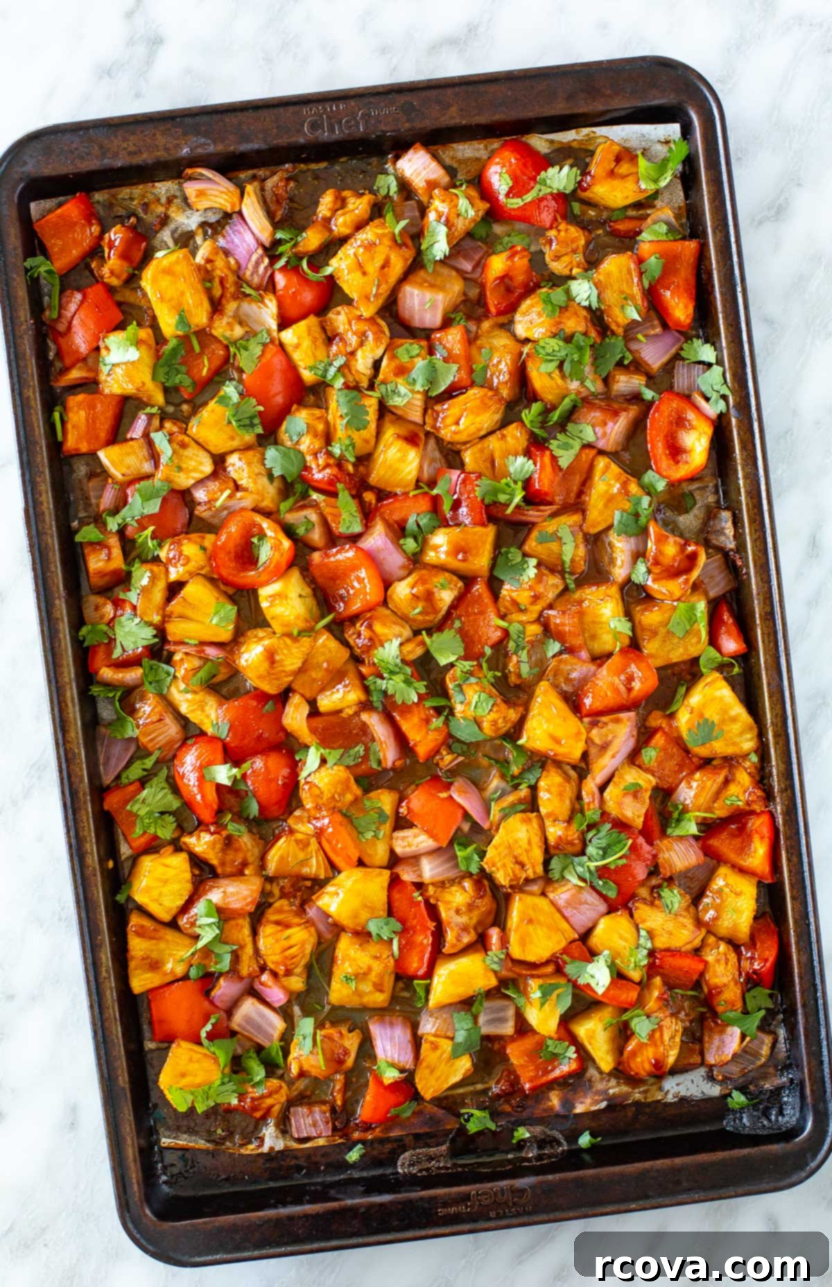 One-Pan Hawaiian Chicken 2 overhead shot of hawaiian chicken in a sheet pan, cooked to perfection with vibrant colors