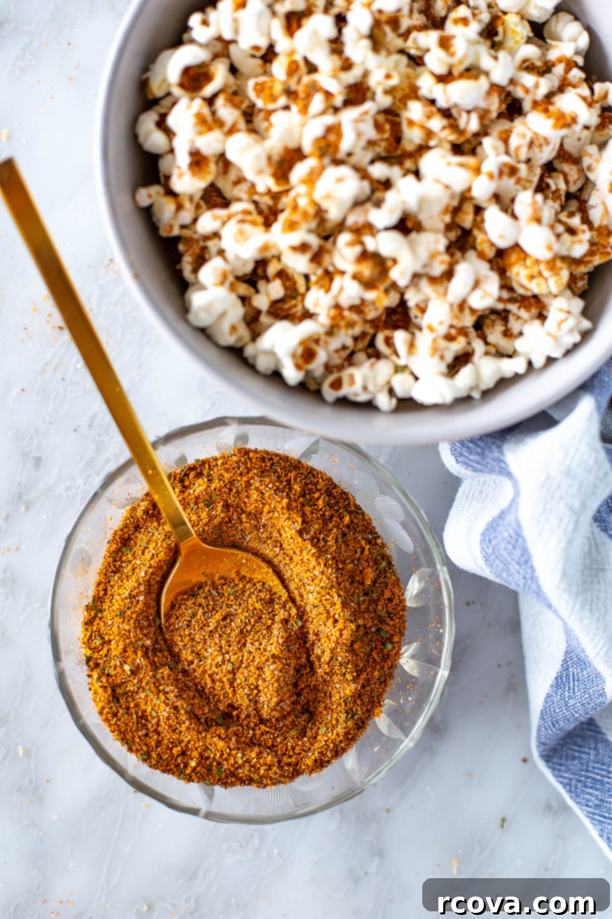 Trader Joe Inspired Elote Seasoning 2 Homemade Elote Seasoning blend in a shaker, surrounded by fresh popcorn and corn on the cob, ready to elevate your snacks.