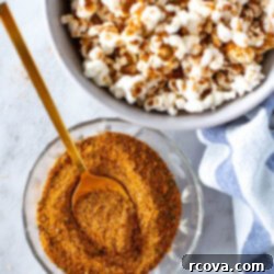 Trader Joe Inspired Elote Seasoning 8 Top-down view of Elote seasoning in a spice shaker, accompanied by a bowl of seasoned popcorn, ready for a flavorful snack.